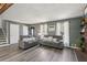 Spacious living room with wood-look floors, two couches, and view of fireplace and staircase at 2491 Falcon Ridge Dr, Grayson, GA 30017