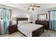 Comfortable main bedroom with ceiling fan, large windows and dark wood furniture at 2491 Falcon Ridge Dr, Grayson, GA 30017