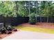 Private backyard with a stained horizontal fence, small patio, and green grass at 407 Johnson Ct, Alpharetta, GA 30009