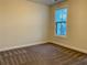 This is a small bedroom with neutral colored walls and carpet at 407 Johnson Ct, Alpharetta, GA 30009