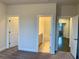 This bedroom has a view of the bathroom and walk-in closet from the bedroom at 407 Johnson Ct, Alpharetta, GA 30009