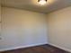 This is a small bedroom with neutral colored walls and carpet with ceiling light at 407 Johnson Ct, Alpharetta, GA 30009
