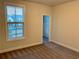 This is a bedroom with neutral colored walls and carpet and an open closet at 407 Johnson Ct, Alpharetta, GA 30009