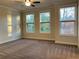 Spacious bedroom with three large windows offering ample natural light and neutral colored carpet at 407 Johnson Ct, Alpharetta, GA 30009