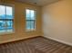 This is a large bedroom with two windows and neutral colored walls and carpet at 407 Johnson Ct, Alpharetta, GA 30009