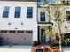Beautiful townhome featuring brick accents, a two-car garage and meticulously landscaped yard at 407 Johnson Ct, Alpharetta, GA 30009