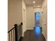 Hallway with dark wood floors, white trim, and doors leading to various rooms in the home at 407 Johnson Ct, Alpharetta, GA 30009