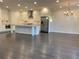 Spacious kitchen with stainless steel appliances, an island, white cabinets, and hardwood floors at 407 Johnson Ct, Alpharetta, GA 30009