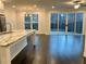 Open-concept kitchen featuring a large island, stainless steel appliances, and backyard views at 407 Johnson Ct, Alpharetta, GA 30009