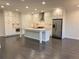 Open kitchen boasts an island with a waterfall marble countertop and stainless appliances at 407 Johnson Ct, Alpharetta, GA 30009