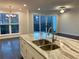 Bright living room showcases an island with a waterfall marble countertop and backyard access at 407 Johnson Ct, Alpharetta, GA 30009