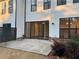 Back patio with brick trim, dark privacy fence, sliding glass doors, and ample space at 407 Johnson Ct, Alpharetta, GA 30009