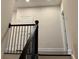 Staircase with dark wood railing and trim with white walls and doors on the upper level at 407 Johnson Ct, Alpharetta, GA 30009