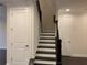 Staircase with dark wood treads and white risers, leading to the upper level at 407 Johnson Ct, Alpharetta, GA 30009