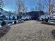 Street view of townhome community with shared green space and guest parking at 407 Johnson Ct, Alpharetta, GA 30009
