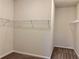 Walk-in closet with carpet and built-in wire shelving for organizing clothes and accessories at 407 Johnson Ct, Alpharetta, GA 30009