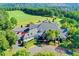 Expansive aerial view of the clubhouse and beautiful, lush landscaping with an adjacent golf course at 7940 Royal Melbourne Way, Duluth, GA 30097