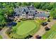 Aerial image of the clubhouse, meticulously landscaped gardens, and adjacent putting green at 7940 Royal Melbourne Way, Duluth, GA 30097