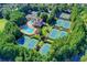 Beautiful aerial view of the community pool, clubhouse, and tennis courts surrounded by lush trees at 7940 Royal Melbourne Way, Duluth, GA 30097