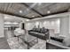 Basement area with grey sofa, accent rug, wooden ceilings, and open floor plan at 7940 Royal Melbourne Way, Duluth, GA 30097
