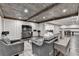 Spacious finished basement with exposed wood ceiling, gray walls, and stylish furnishings at 7940 Royal Melbourne Way, Duluth, GA 30097