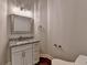 Modern bathroom with a granite countertop, framed mirror, and neutral color palette at 7940 Royal Melbourne Way, Duluth, GA 30097