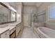 A bright bathroom with granite countertops, shower and soaking tub at 7940 Royal Melbourne Way, Duluth, GA 30097
