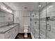 Modern bathroom features a glass-enclosed shower, granite countertops, and updated fixtures at 7940 Royal Melbourne Way, Duluth, GA 30097
