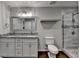 Elegant bathroom with granite countertops, dual sinks, and a modern glass shower for a spa-like retreat at 7940 Royal Melbourne Way, Duluth, GA 30097