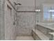 The shower in this bathroom features a bench and marble tile walls at 7940 Royal Melbourne Way, Duluth, GA 30097