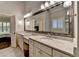 This bathroom features double sinks, vanity seating and granite countertops at 7940 Royal Melbourne Way, Duluth, GA 30097