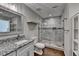 Clean bathroom with granite countertops, a sink, a modern glass shower, and natural lighting at 7940 Royal Melbourne Way, Duluth, GA 30097