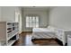 A simplistic bedroom with hardwood floors, natural light, and neutral tones, creating a clean and inviting atmosphere at 7940 Royal Melbourne Way, Duluth, GA 30097