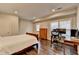 Cozy bedroom featuring natural light, wood floors, and a functional work area at 7940 Royal Melbourne Way, Duluth, GA 30097