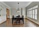 Formal dining room with hardwood floors, wainscoting and shuttered windows perfect for entertaining guests at 7940 Royal Melbourne Way, Duluth, GA 30097