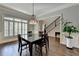 Traditional dining room with chandelier and hardwood flooring near staircase at 7940 Royal Melbourne Way, Duluth, GA 30097