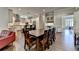 Open-concept space features a long wood dining table and hardwood floors throughout at 7940 Royal Melbourne Way, Duluth, GA 30097