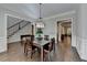 Elegant dining room with adjacent staircase and detailed trimwork; perfect for Gathering gatherings at 7940 Royal Melbourne Way, Duluth, GA 30097