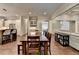 Open-concept dining room with hardwood floors, and views into other living spaces at 7940 Royal Melbourne Way, Duluth, GA 30097