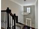 Foyer boasts modern lighting and dark railings on stairs at 7940 Royal Melbourne Way, Duluth, GA 30097