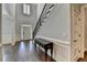 Welcoming foyer with a staircase, dark hardwood floors, and classic wainscoting at 7940 Royal Melbourne Way, Duluth, GA 30097