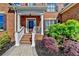 Inviting front entry with brick steps, white railings, and colorful landscaping at 7940 Royal Melbourne Way, Duluth, GA 30097