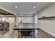 Bright game room with ping pong table, finished floors, and adjacent living area at 7940 Royal Melbourne Way, Duluth, GA 30097