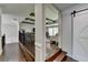 Hallway view of the beams in the living room and a barn door to the right at 7940 Royal Melbourne Way, Duluth, GA 30097