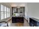 Inviting home office featuring custom built-ins, a modern desk, and natural light from the window at 7940 Royal Melbourne Way, Duluth, GA 30097