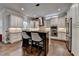 Modern kitchen with stainless appliances, granite countertops, white cabinetry and a center island with seating at 7940 Royal Melbourne Way, Duluth, GA 30097