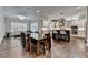 Open concept kitchen and dining area with hardwood floors and an abundance of natural light at 7940 Royal Melbourne Way, Duluth, GA 30097