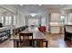 Spacious kitchen with a long dining table with view of a living room at 7940 Royal Melbourne Way, Duluth, GA 30097