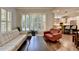 Open living room and kitchen area with hardwood floors and bright, natural light at 7940 Royal Melbourne Way, Duluth, GA 30097