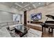 This living room showcases a modern fireplace, grand piano, and natural lighting at 7940 Royal Melbourne Way, Duluth, GA 30097
